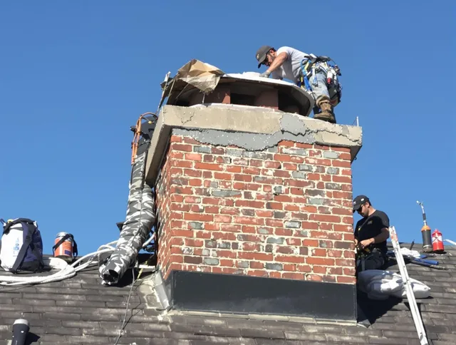 Southborough Chimney Sweep installing a custom chimney crown in Southborough, MA
